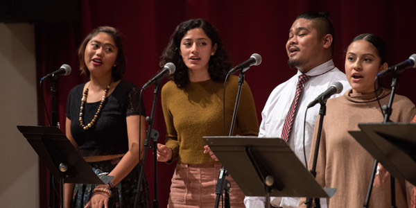 Four Students singing in a performance
